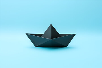 Closeup of a black paper boat on blue background	
