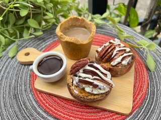 Eatable cup of Coffee and baked potatoes with chocolate mixed milk ice cream