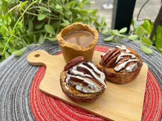 Eatable cup of Coffee and baked potatoes with chocolate mixed milk ice cream
