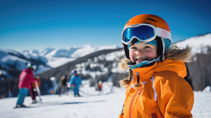 Portrait of a kid skier in helmet and winter clothes on the background of snow-covered mountain slope - obrazy, fototapety, plakaty