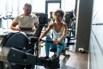 Physically, challenged fitness instructor trains his female client, demonstrating determination and dedication to their fitness journey.