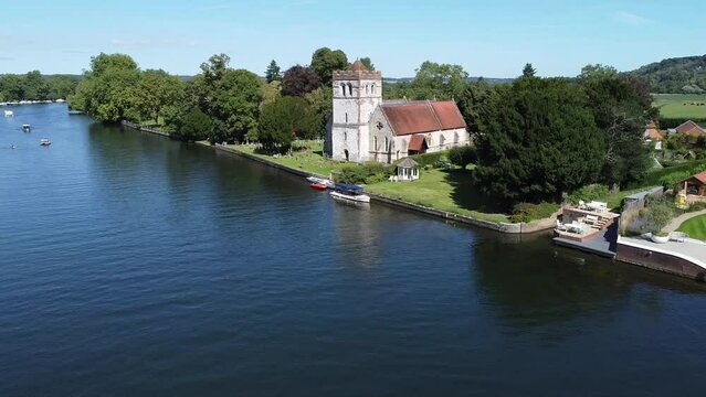Drone shot of the All Saints Church and houses in Bisham village on the Thames in Berkshire, England