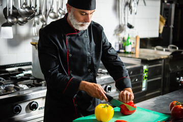 Chef cutting a red pepper - Powered by Adobe
