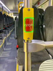 Button stop on hand rail. Stop button on city or extra-urban buses. Public transportation