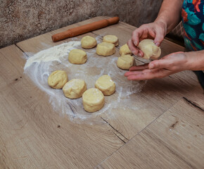 The hostess prepares pies in the kitchen.Working with pastry on the table.Cooking food.