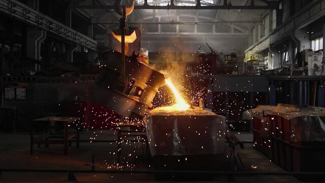 pouring molted metal liquid from blast furnace. Steel production