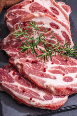 Raw pork neck meat. Chop steak, red peppercorn, garlic cloves, sea salt and fresh rosemary