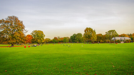 Mannheim, Germany. Playground for children and families. Panoramic view over Luisen city park at sunset golden Autumn colors. Cityscape in the historical downtown at sunny day and milky blue sky.