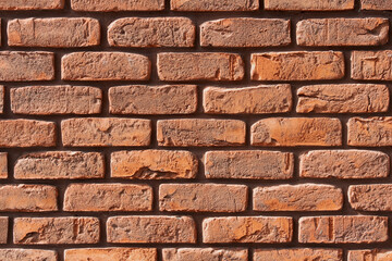 Brown, red brick wall background with seams. Space for text. Texture close-up.