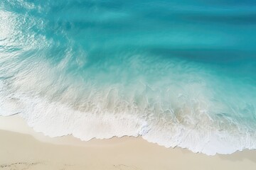 An Aerial View Of A Beach With A Wave Coming In