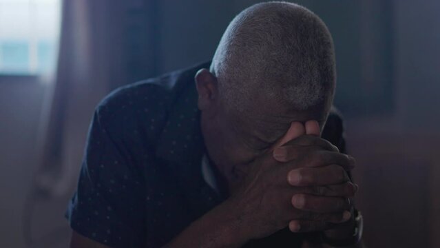 Close-up of a Religious black senior man in PRAYER, Spiritual person on his knees asking for divine intervention