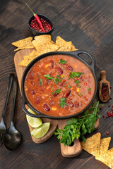 Mexican food chili con carne with corn chips nachos. Bean and corn soup, kidney bean stew