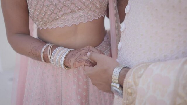 Indian Hindu Couple holding each other hands during their marriage Function. Close up slow motion Video.