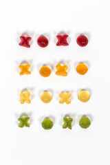 XOXO -spelled with gummy candy letters in four colors isolated on a white background