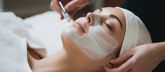 young woman having facial mask spa therapy in beauty salon
