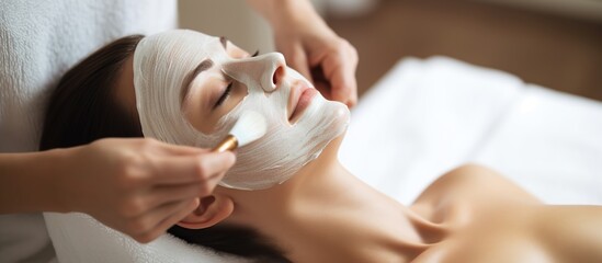 Naklejka premium young woman having facial mask spa therapy in beauty salon