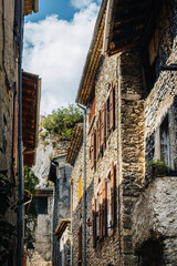 Old house stone facades with shutters in the medieval village of Chatillon en Diois, in the south of France (Drome)