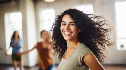 A joyful and enthusiastic healthy woman vegan dancing in a lively fitness class, blurred...
