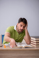 Young male student sitting in front of whiteboard