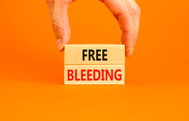 Free bleeding symbol. Concept words Free bleeding on beautiful wooden block. Beautiful orange table...