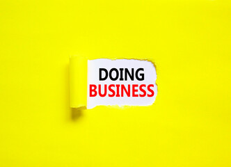 Doing business symbol. Concept words Doing business on beautiful white paper. Beautiful yellow paper background. Business, motivational Doing business concept. Copy space.