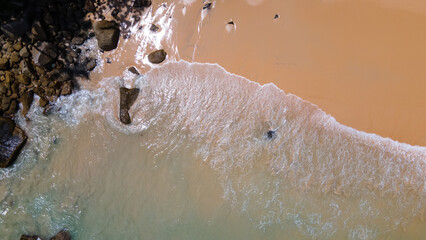 Fototapeta premium Beautiful beach with colorful water. Top view of the beautiful coastline. Sunny summer day. Colorful water. Sandy beach. 