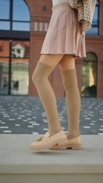 Female legs in a short skirt and stockings