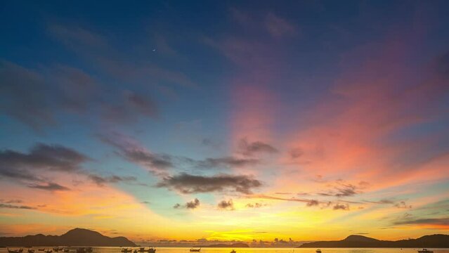 .Time lapse amazing yellow Light through the sky above the islands. .Beautiful sunrise are accompanied by soft clouds floating in stunning sky..Beautiful sunrise soft clouds floating above the sea..