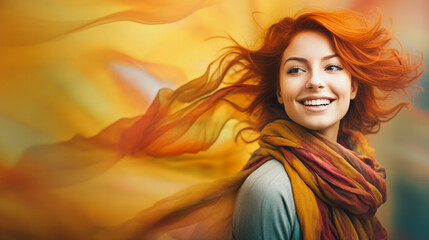Fototapeta premium A beautiful, smiling young woman with red hair, wearing a long, colorful scarf billowing in the wind in autumn colors.