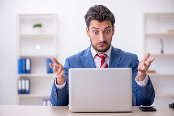 Young male employee working in the office