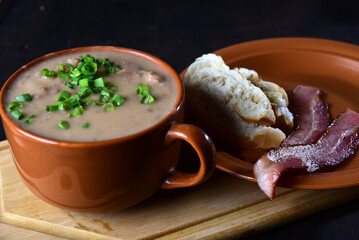 delicious bean broth with bacon, bread and pepper, typical Brazilian food.