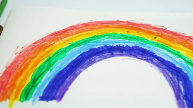 Drawing of a rainbow drawn with felt-tip pens in a sketchbook by a small child