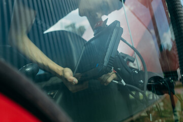 Young engineer installing autopilot system on tractor © andrew_shots