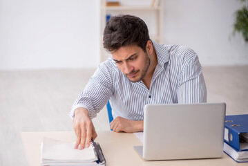 Young male employee working in the office