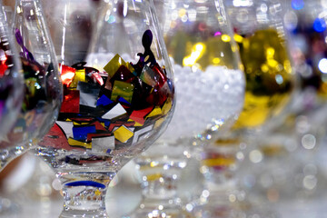 Glass glasses filled with confetti.