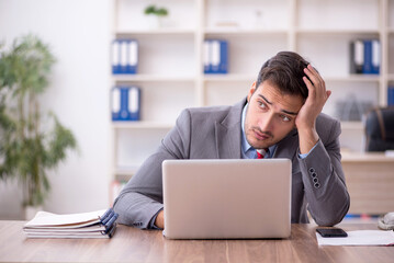 Young male employee working in the office