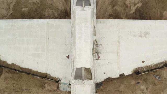 Aerial view of an abandoned Soviet Lun-class ekranoplan on the Caspian Sea coast. Detailed shooting 4k