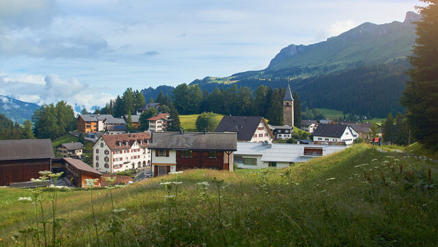 Churwalden village in Switzerland. Formerly Parpan. Beautiful swiss alpine countryside with a medieval bell tower and Rothorn mountain on background.
