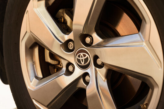 The Toyota company logo is on a car wheel.