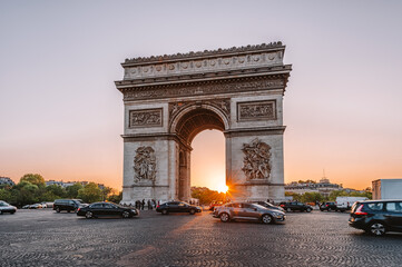 Paris Arc de Triomphe (Triumphal Arch) in Chaps Elysees at sunset, Paris, France. Cityscape of...