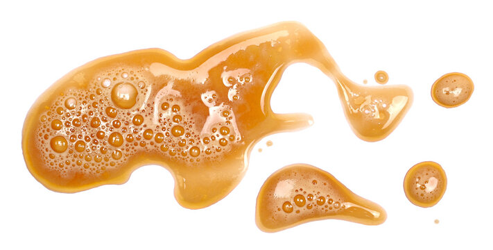 Spilled dark stout beer puddle  with foam, isolated on white, top view, clipping path 