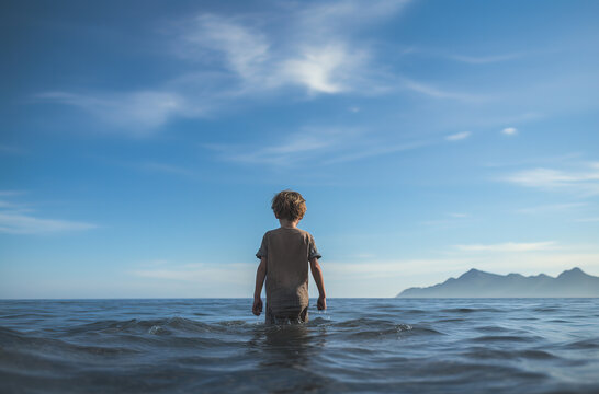 a boy stands in the water against the background of the sea, generative ai 