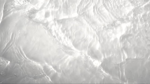 Pure beige water with reflections sunlight in slow motion. Water surface texture top view. Sun and shadows. Motion clean swimming pool ripples and wave, Full HD.
