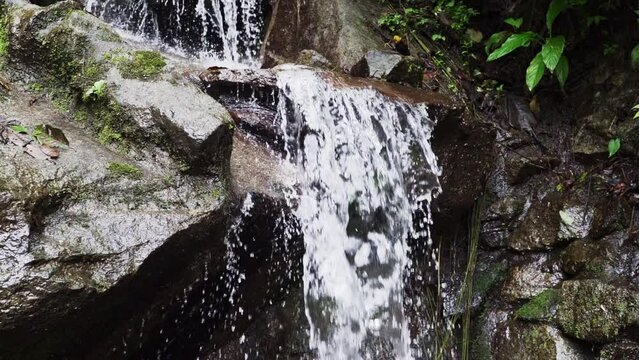 rainforest at the spectacular waterfall of El Pailon del Diablo close to Banos Santa Agua in the andes mountains of Ecuador, South America.