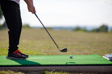 Golf Sport Concept : Ball and Golf club on artificial grass in golf driving range for training of golfer.