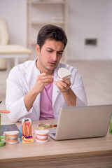 Young male dentist working in the clinic