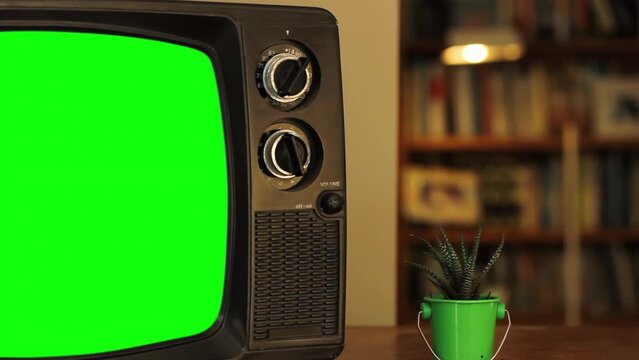 A Vintage TV Green Screen in the Living Room of a House. Close Up. You can replace green screen with the footage or picture you want with “Keying” effect in After Effects. 4K.