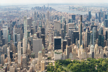 Fototapeta premium Aerial panoramic city view of Midtown Manhattan neighborhoods towards lower Manhattan and Downtown, Central Park on bottom, New York City. Bird's eye view from helicopter of metropolis cityscape