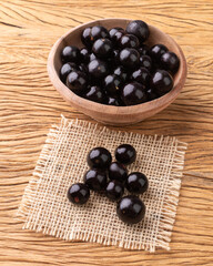 Jabuticabas on a bowl over wooden table