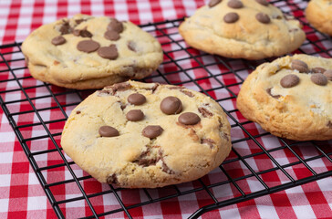 Chocolate chip cookies on a grid over plaid fabric